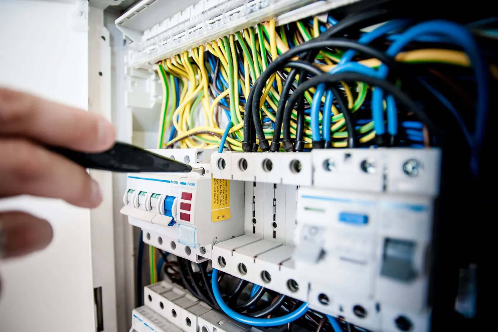 Elektrofachkraft prüft die Verdrahtung eines Verteilers